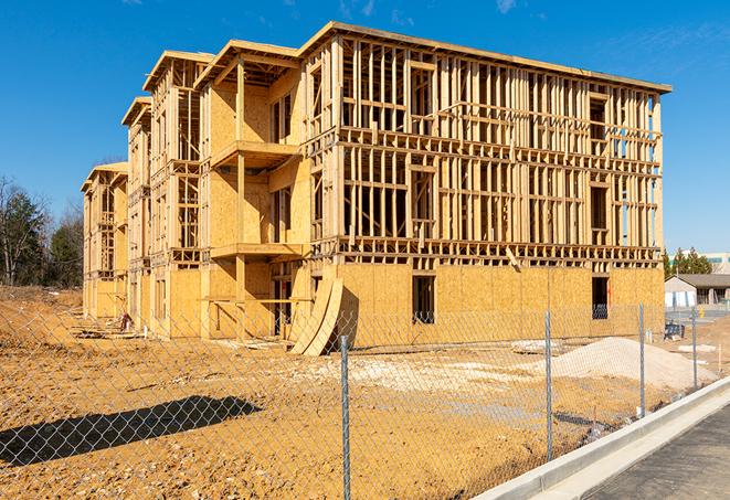 a close-up of temporary chain link fences enclosing a job site, signaling progress in the project's development in Arverne, NY